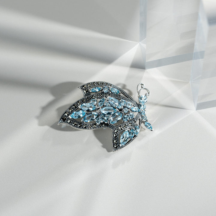 Art Nouveau Style Marquise Blue Topaz & Marcasite Flying Butterfly Brooch in 925 Sterling Silver flatlay