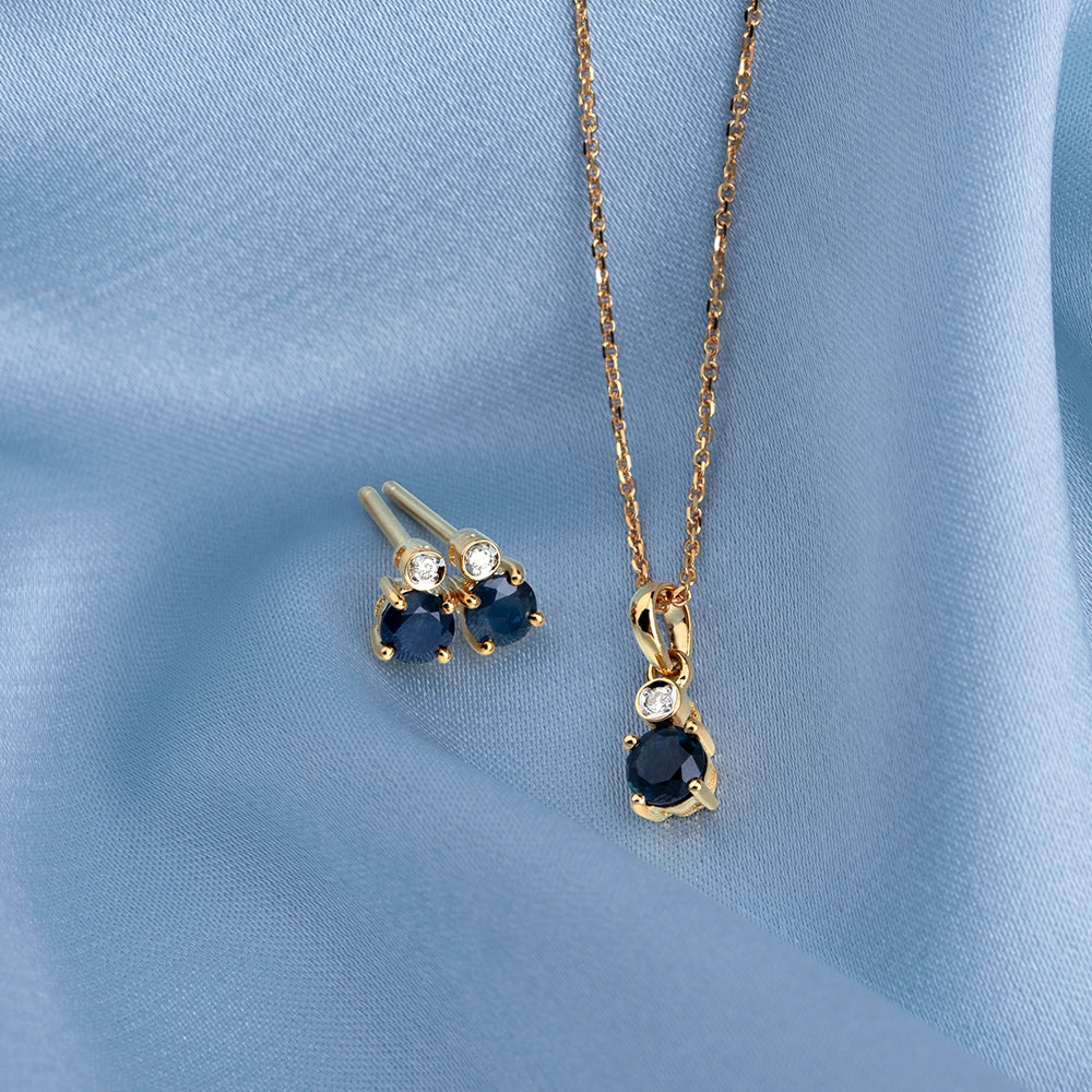 Microstatement_round_sapphire_and_diamond_pendant_necklace_and_stud_earrings_in_9ct_yellow_gold