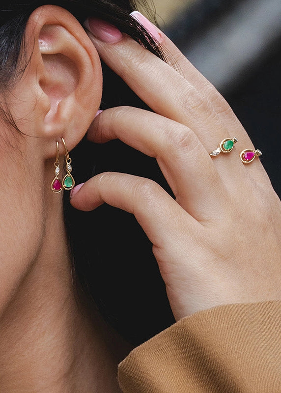 Close-up of a woman wearing earrings with a blurred background